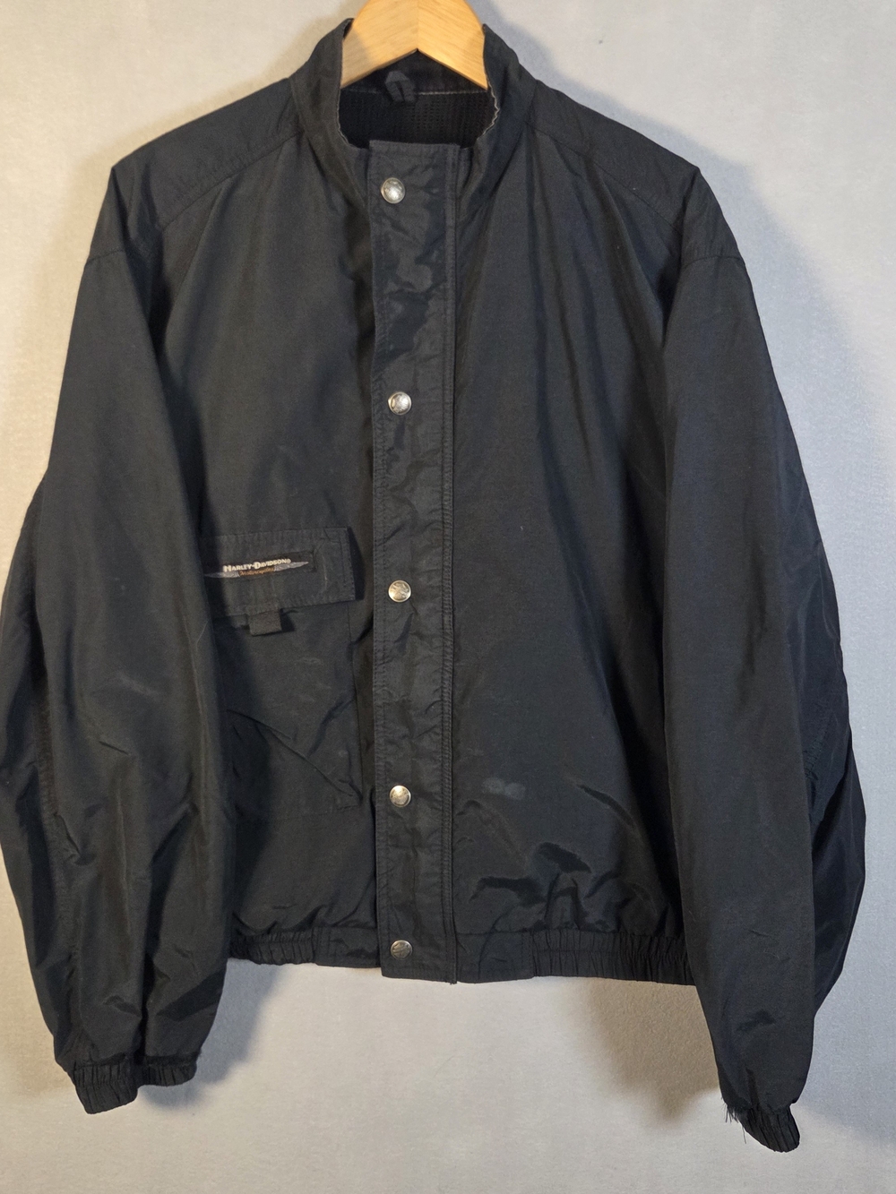 Vintage Harley-Davidson nylon windbreaker featuring a reflective winged logo